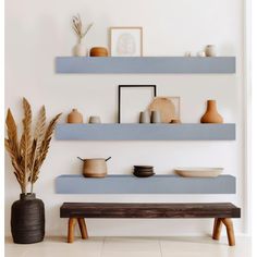 two shelves with bowls and plates on them