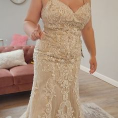 a woman in a wedding dress is posing for the camera with her hand on her hip