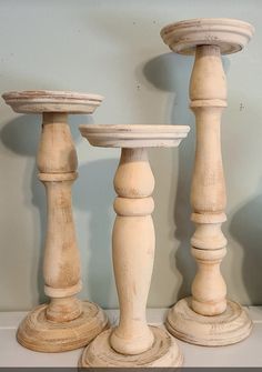 three wooden candlesticks sitting next to each other