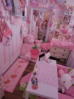 a room filled with lots of stuffed animals and decorating it's walls in pink