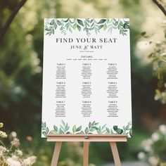 a seating chart on an easel in front of some flowers and greenery with the words find your seat