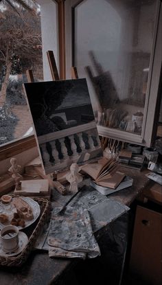 an artist's easel with paint and brushes on it