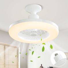 a white ceiling light with green leaves coming out of the center and on top of it