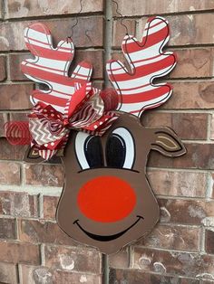 a reindeer head hanging on the side of a brick wall