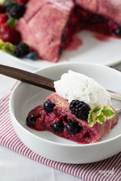 a bowl with berries and ice cream in it next to another bowl filled with cake