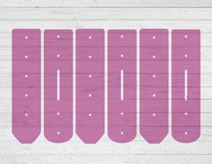 six pink snowboards are lined up against a white wood background with polka dots on them