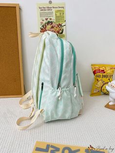 a backpack sitting on the floor next to some cereal