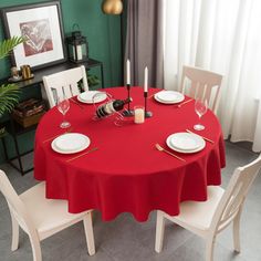 a red table with white chairs and plates