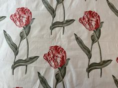 red flowers on white fabric with green leaves