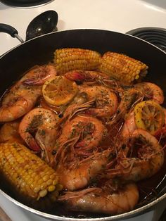 cooked shrimp and corn in a pan on the stove