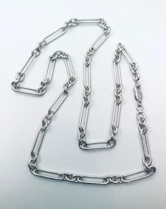 "inspired by my grandfathers watch chain of over 100 years ago. this is heavy (42 grams) solid silver 24\" long" Sterling Silver Bracelet With Rectangular Links And Polished Finish, Sterling Silver Bracelet With Polished Rectangular Links, Timeless Sterling Silver Bracelet With Rectangular Links, Oval Silver Stainless Steel Necklace, Polished Finish Sterling Silver Link Bracelet, Polished Sterling Silver Link Bracelet, Sterling Silver Link Bracelet With Polished Finish, Timeless Sterling Silver Bracelet With Silver Chain, Formal Sterling Silver Bracelet With Rectangular Links