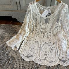 The Twin Falls Crochet Cotton Lace Long Sleeve Blouse by Lavender Tribe Design.  We are obsessed with this Darling Lace Blouse. This pretty blouse features a soft white semi-sheer cotton base, a soft scoop neck, crochet lace details and feminine fit. + Well made + Soft Cotton Blend + Long Sleeves + Scalloped Hem + True to Size  + Heather is 5'8" tall / 140lbs and modeling a size Medium FREE SHIPPING FOR US CUSTOMERS! Ships fast from our studio in Washington State! Approx. Measurements: Small: Pit to pit: 18", Length: 27"  Medium: Pit to pit: 19", Length: 29"  Large:  Pit to pit: 20", Length: 30"  XL:  Pit to pit: 21", Length: 30"  ** Double pit to pit for total bust measurement Fit Guide: Blouse are a slimmer cut.  If you have a larger chest size we would size up one size.  About Us: Laven Bohemian Long Sleeve Crochet Lace Blouse, Spring Bohemian Scalloped Lace, Bohemian V-neck Crochet Lace Top, Bohemian Long Sleeve Lace Patchwork Top, Bohemian Long Sleeve Crochet Lace Top, Bohemian Long Sleeve Lace Crochet Top, Long Sleeve Scalloped Lace Top For Summer, Bohemian Long Sleeve Lace Top, Lace V-neck Blouse With Crochet Trim