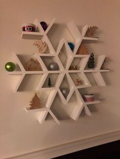 a snowflake is mounted on the wall with shelves