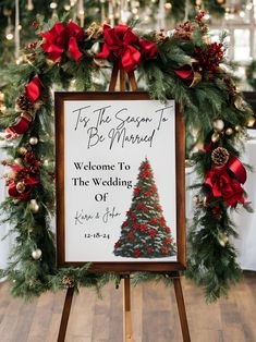 a sign that is sitting on top of a easel with christmas decorations around it