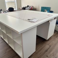 a large white desk sitting on top of a hard wood floor