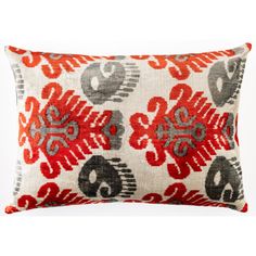 a red and grey pillow with an ornate design on it's side, against a white background