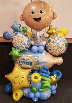 a baby's 1st birthday balloon arrangement with balloons and heliums in the shape of a star