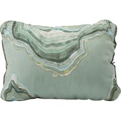 a green pillow with an abstract design on the front and back, sitting on a white background