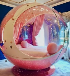 there is a pink bed with stars on it in the shape of a bubble ball