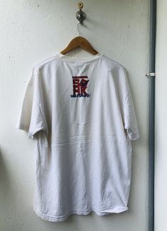 "\"Vintage\" is a term that we don't take lightly. Our shops only feature tees that have been aged no less than 15 years. PLEASE ASK ANY QUESTION BEFORE BUYING THIS IS USED CLOTHING PLEASE DONT EXPECTED IT TO BE LIKE NEW OR IN PRISTINE CONDITIONPLEASE REFER TO THE ACTUAL/MANUAL SIZE TAKEN armpit to armpit= 23\"inches Lenght from top of the shoulder to bottom= 29\"Inches In a good vintage condition Used clothing Sold as it Please double click on Photo for full spec (Kindly refer to the last photo Retro White T-shirt With Back Print, White Retro T-shirt With Back Print, Vintage Tan Short Sleeve Tops, Vintage Style Tan Cotton Tops, Retro White Tops With Back Print, White Vintage T-shirt For Streetwear, Vintage Cotton Tops With Back Print, Vintage T-shirt With Back Print And Relaxed Fit, Vintage Tops With Back Print In Relaxed Fit