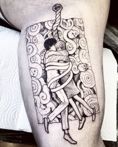 a man's leg with a tattoo on it and an image of a woman holding a knife