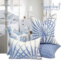 blue and white pillows are stacked on top of each other