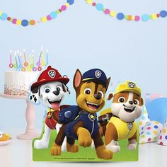 a birthday card with three cartoon dogs on it and a cake in the background that says paw patrol