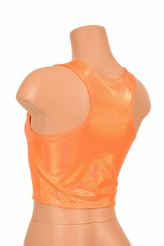 "This item is made to order, please read all the way through the listing before purchasing! This sizzling hot orange holographic crop top has an amazing rainbow shine! It features a scoop neckline in front and an edgy racerback design in the back. It is made of four way stretch lycra spandex, and it fits like a glove! Super figure flaunting and fun! This top is just perfect when paired with any of our bike shorts or high waist leggings for a sporty look. LENGTH: 8\" (from the underarm to the hem Fitted Metallic Shiny Crop Top, Metallic Shiny Fitted Crop Top, Orange Stretch Crop Top, Stretch Orange Cropped Top, Fitted Orange Cropped Top, Fitted Cropped Orange Top, Metallic Fitted Disco Crop Top, Fitted Metallic Crop Top For Summer, Fitted Disco Crop Top