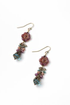 From the Mauve collection these earrings are longer in design and handcrafted with a fun Czech glass flower focal. Antique Brass (nickel and lead-safe) Czech Glass 2.5", with antique brass ear wires We hand select our natural materials, thus there may be slight variations in color and/or size that will not detract from the overall aesthetic Our unique handcrafted designer jewelry for women is made in America, each design created individually in our personal design studio in Floyd VA USA Handmade Czech Glass Flower Dangle Earrings, Bohemian Czech Glass Dangle Flower Earrings, Nickel-free Czech Glass Flower Earrings, Bohemian Glass Beaded Earrings With Ear Wire, Bohemian Beaded Earrings With Glass Ear Wire, Handmade Czech Glass Flower Earrings In Vintage Style, Handmade Czech Glass Vintage Flower Earrings, Handmade Vintage Czech Glass Flower Earrings, Vintage Czech Glass Flower Earrings For Gift