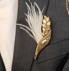 Add a touch of bohemian elegance to your outfit with this stunning handmade wheat spikelet brooch. With delicate feathers and shimmering golden crystals, this unique piece is sure to make a statement.  Perfect as a birthday gift for a loved one or as a special treat for yourself, this brooch will add a touch of nature-inspired beauty to any look. Stand out from the crowd with this unique accessory. Size: Length: 3 3/8 in.;  Width: 1 1/8 in. **PACKAGING** The product is packed in a box. It is con Gold Feathered Jewelry For Parties, Gold Feathered Wedding Jewelry, Gold Feather Jewelry For Wedding, Elegant Gold Brooches For Celebration, Men's Brooch, Golden Crystal, Accessories Unique, Beaded Flowers, Wheat