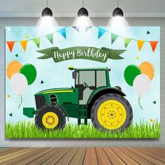 a green tractor with balloons and streamers on the back is in front of a birthday card