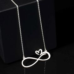 Elevate your style with the timeless elegance of the Sussex Home Heart Infinity Necklace. This exquisite piece symbolizes eternal love, crafted meticulously by hand from sterling silver, ensuring each necklace is unique and of the highest quality. Perfect for bridesmaids, friends, or a special treat for yourself, this necklace adds a touch of sophistication to any outfit.

- Material: Sterling Silver
- Color: Silver
- Gender: Female
- Age Group: Adult

To maintain the necklace's luster, avoid di Minimalist Clavicle Chain Jewelry For Anniversary, Elegant Stainless Steel Wedding Necklaces, Elegant Stainless Steel Necklace For Wedding, Minimalist Infinity Necklace For Anniversary Gift, Minimalist Infinity Necklace For Anniversary, Silver Metal Jewelry For Anniversary Gift, Elegant Adjustable Necklace For Anniversary Gift, Elegant Adjustable Necklaces For Anniversary Gifts, Silver Metal Jewelry Gift