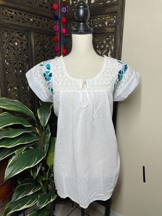 Precious Embroidered Blouse made in Puebla, Mexico by our Mexican partners. Super light weight and fresh looking. The embroidered design is beautiful and delicate. All the work is clean, and with a professional finish and hand embroidered. You will look gorgeous for a friends night out or a summer cookout day, your call. You will Love it either way.... :) Blouse STYLE DETAIL Overview * soft cotton fabric * round-neck * hand embroidered design * short sleeves fit & sizing MEDIUM fabric & Fitted Short Sleeve Embroidered Top, Fitted Short Sleeve Top With Embroidered Hem, Casual Fitted Blouse With Intricate Embroidery, Fitted Embroidered Short Sleeve Top, Fitted Embroidered Top With Short Sleeves, Fitted Casual Embroidered Top With Intricate Embroidery, Casual Fitted Embroidered Top With Intricate Embroidery, Fitted Casual Top With Intricate Embroidery, Fitted Short Sleeve Blouse With Embroidered Hem