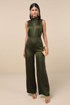 You'll feel like total royalty in the Lulus Classic Elegance Olive Green Satin Sleeveless Mock Neck Jumpsuit! Luxe woven satin shapes this chic jumpsuit that has a mock neckline and a sleeveless bodice with gathered fabric detailing. Fitted waist tops wide legs that end at ankle-length hems. Keyhole opening and double button closure at back. Hidden back zipper/clasp. Fit: This garment fits true to size. Length: Floor length. Size medium measures 61.25" from shoulder to hem. Inseam: 32.25 Front R Jumpsuits For Wedding Guest, Elegant Fitted High Neck Jumpsuit, Elegant Satin Jumpsuit Or Romper In Solid Color, Elegant Satin Jumpsuits And Rompers For Summer, Sleeveless Satin Jumpsuit Or Romper, Chic Formal Satin Jumpsuits And Rompers, Sleeveless Satin Jumpsuits And Rompers, Sleeveless Solid Color Satin Jumpsuits And Rompers, Glamorous Satin Jumpsuits And Rompers For Evening