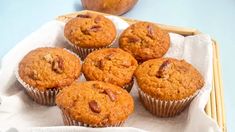 several muffins in a basket on a table