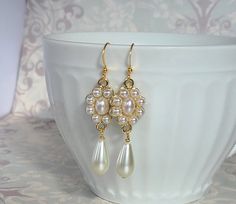 "Lovely pearl teardrop earrings as seen in many a classic portrait from the 18th and 19th centuries! These beautiful earrings feature ivory glass teardrop pearls. Gorgeous earrings with that old world historical style. They're perfect for the bride or bridesmaid. The earrings hang about a 1 1/2\" long from gold plated earwires. Comes in a lovely gift box with ribbon." Victorian White Pearl Earrings As Gift, Victorian White Gold Drop Earrings, Victorian Teardrop Earrings, Ornate White Pearl Drop Earrings, White Victorian Pearl Drop Earrings, Victorian Drop Earrings, Pearl Teardrop Earrings, Celtic Knot Jewelry, Ivory Earrings