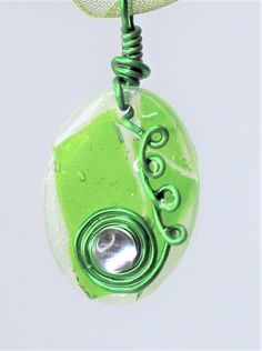 This dainty Pendant is made with Chartreuse cathedral glass and set in a glittery green resin. It is wire wrapped with green wire and has a small glass bead embellishment. The pendant has a handmade bail made from green wire as well. The pendant comes o an 18" Organza Green necklace. It is very unique and it an accessory must have. This glass piece will go well with black outfits and others as well. It is handmade so it is one of a kind. Bead Embellishment, Dainty Pendant, Black Outfits, Resin Necklace, Green Necklace, Glass Necklace, Glass Bead, Green Glass, Glass Pendants