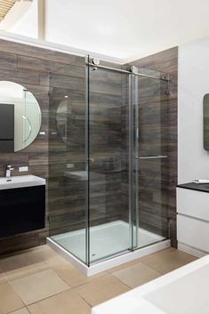 a bathroom with a walk in shower next to a sink