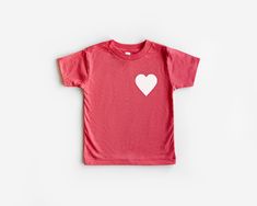 Valentines Day Heart Shirt, Love Shirt, Matching Shirts, Mommy And Me Shirts, Happy Valentines Day, Valentines Day Gift, Kids Shirts, Heart CARE * Please wash inside out, in cold water * Tumble dry low or hang dry if desired * No fabric softeners and a Mild Detergent * Do not iron over graphic DETAILS * All items are handmade from professional and high quality materials. * Each piece is created with great attention to detail. Orders are made-to-order and will be shipped out in 3-5 business days Pink Heart-shaped Top For Valentine's Day, Playful Graphic Print T-shirt For Valentine's Day, Cute Heart Print Tops For Valentine's Day, Playful Cotton T-shirt With Heart Graphic, Playful Valentine's Day Crew Neck T-shirt, Cute Red Heart-shaped Top, Valentine's Day Shirt With Heart Graphic, Heart Graphic Shirt For Valentine's Day Gift, Playful Crew Neck T-shirt For Valentine's Day