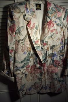 "Floral spring jacket by Sam Moire.  Bust measures 42\", length 29\".  Fabric is poly and rayon.  Looks like linen and silk.  No flaws of any kind.  Stored with TLC.  Comes from a smoke-free home." Silk Long Sleeve Blazer With Floral Print, Summer Silk Formal Outerwear, Silk Blazer With Notch Lapel For Spring, Silk Long Sleeve Summer Outerwear, Vintage Floral Print Blazer For Spring, Spring Silk Single Breasted Blazer, Vintage Summer Blazer For Formal Occasions, Vintage Summer Formal Blazer, Spring Silk Single-breasted Blazer