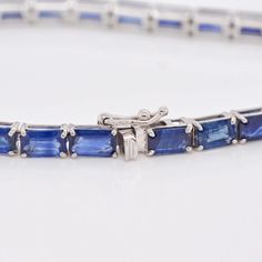 Indulge in the timeless allure of our 18K White Gold Octagon Blue Sapphire Tennis Bracelet—an exquisite blend of sophistication and elegance. Crafted with meticulous precision, this bracelet features a stunning array of octagon-cut blue sapphires, each gemstone meticulously set in lustrous white gold Timeless Blue Bracelet For Formal Occasions, Luxury Blue Diamond Bracelet, Timeless Blue Diamond Bracelet, Classic Emerald Cut Gemstone Bracelets, Elegant Octagon Diamond Bracelet For Formal Occasions, Luxury Sapphire Gemstone Tennis Bracelet, Classic Sapphire Gemstone Tennis Bracelet, Blue Baguette Cut Fine Jewelry, Timeless Asscher Cut Sapphire Jewelry