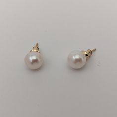 These earrings, featuring cultured saltwater Akoya pearls set in 14K yellow gold, provide a classic and timeless style that enhances any outfit. The round pearls measure 7.5-8.0mm in size, displaying a stunning luster and a bright white color that's beautifully amplified by their natural orient. Set in a versatile stud style, the earrings are suitable for both everyday wear and special occasions. With a lightweight design, they ensure comfort throughout the day. The pearls' clean surface, free f Classic Round Pearl Drop Earrings, Classic Round Pearl Earrings For Anniversary, Classic Pearl Earrings For Anniversary, Timeless Round 14k Gold Pearl Earrings, Classic Pearl White High Luster Earrings, Round Akoya Pearl Earrings, Timeless Akoya Pearl Earrings In Yellow Gold, Classic Pearl Earrings With High Luster, Classic Round Akoya Pearl Earrings