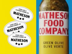 a bottle of green olive oil next to three stickers that say, matheson food company