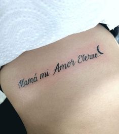 a woman with a tattoo on her stomach that says mama mi amor elevao