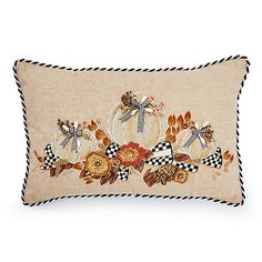 a decorative pillow with pumpkins and leaves on it