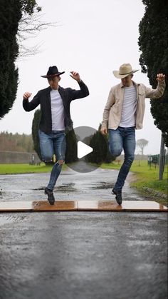 two men are dancing in the rain on their skateboards and one is wearing a cowboy hat