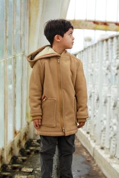 Hooded fleece jacket for boys with double-slider front zipper and two outside zipper pockets and knitted cuffs. Soft cozy fleece lined coat with warm inside fabric layer ensures the body comfort during the cold winter days. Winter coat with zipper with loose silhouette allows kids to move and play free during cold weather conditions. Our warm hooded jacket for toddler boy can be combined with casual trousers or jeans, sweaters and shirts. Hooded Fleece Jacket With Zipper For Cold Weather, Hooded Fleece Jacket With Zipper Closure For Cold Weather, Warm Brown Hooded Jacket, Hooded Outerwear With Plush Lining For Outdoor, Fleece-lined Hooded Jacket, Warm Hooded Parka For Winter, Warm Hooded Parka For Outdoor, Brown Hooded Fleece Jacket With Fleece Lining, Brown Hooded Fleece Jacket