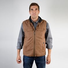 Warm, good-looking, and rugged, the Trek Vest is a seriously functional and versatile layer. Insulated throughout and equipped with a snow top sherpa-lined collar and the back yoke, it curbs the chill without excessive bulk. Patch pockets with sturdy snaps at the chest and an interior cell phone pocket provide handy, on-body security for your valuables. Over a hoodie, paired with a shirt, or layered under your favorite jacket, this rugged vest works hard on the job site and cleans up well for th Unique Canvas, Sherpa Lined, Slim Waist, How To Look Better, Cell Phone, Perfect Fit, Benefits, Collar