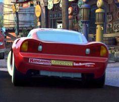 the cars are driving down the street in disney's cars