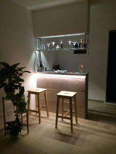 two wooden stools in front of a bar